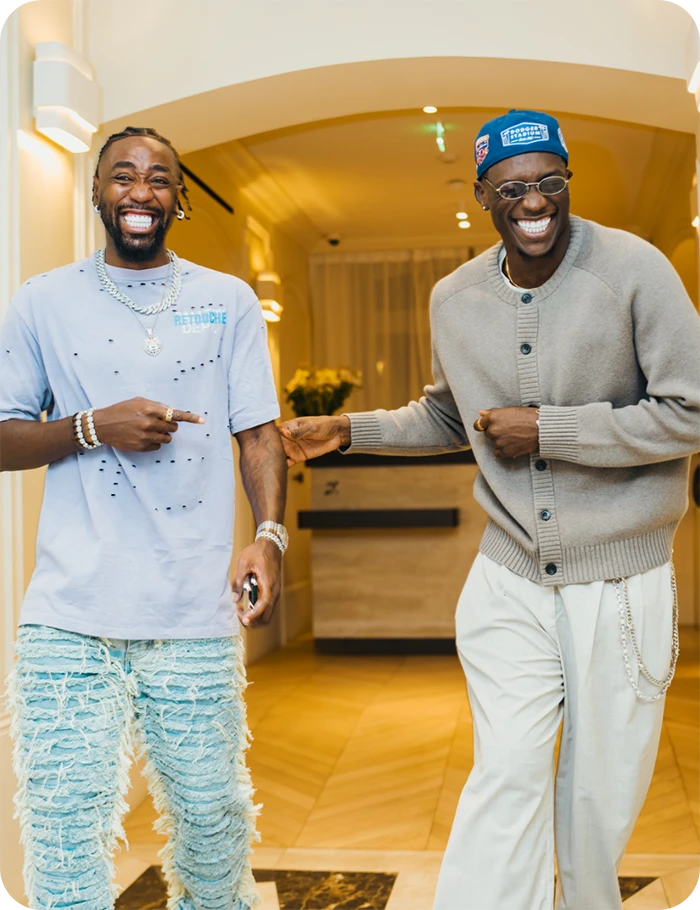 Two smiling patients at Darya Dental Clinic displaying their professional teeth whitening and restoration results.